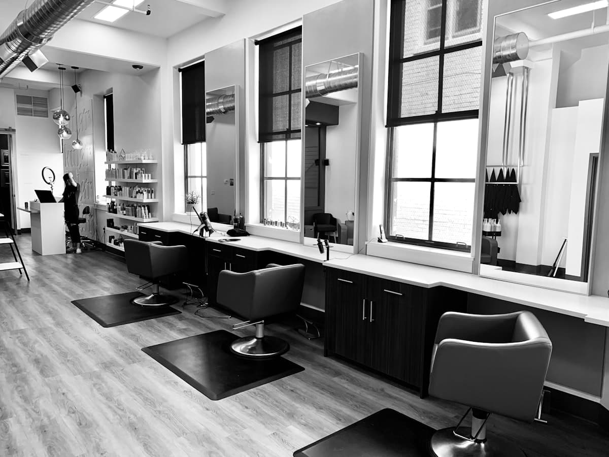 Hair salon styling station with chair and mirror